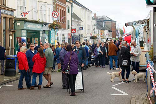A group of people in Honiton High Street during the Gate to Plate food festival